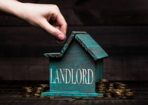 Wooden house model with coins